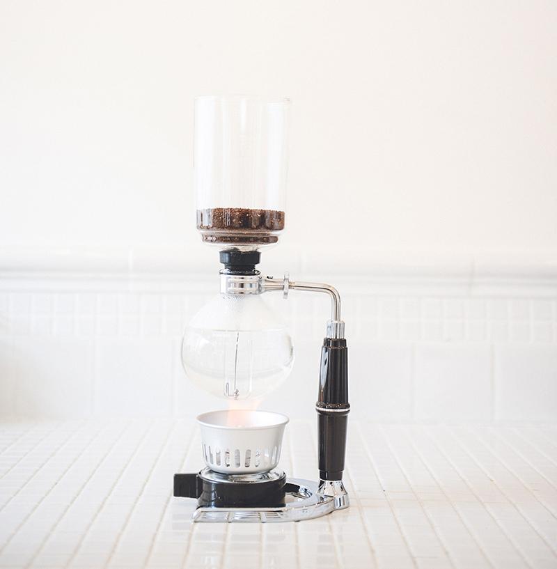 2 Cup Hario Technica Coffee Syphon on a white wooden surface with a white background