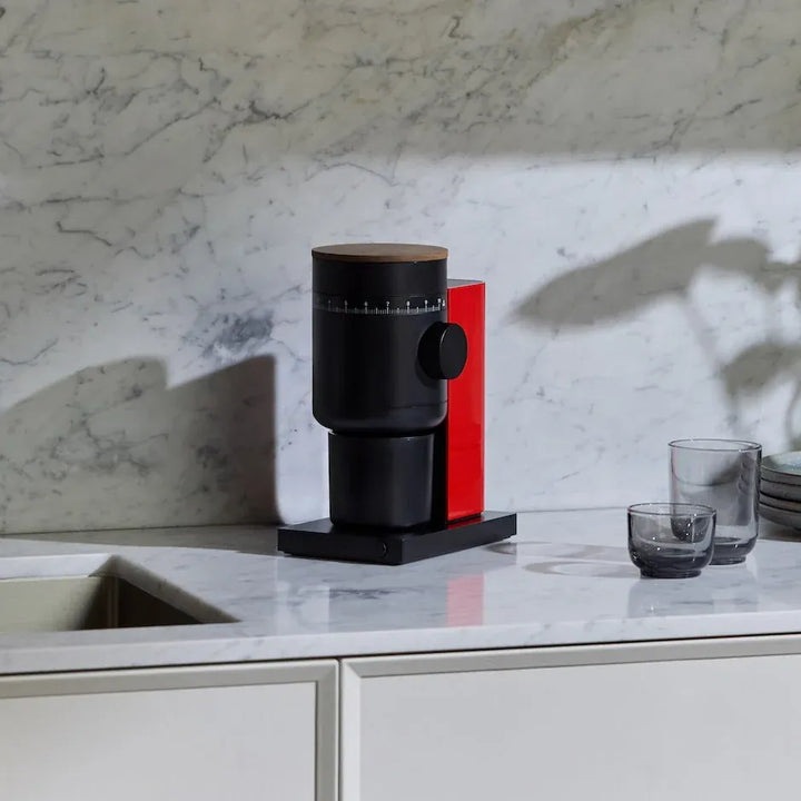 Fellow Opus 2 grinder in Cherry Red + Walnut on a marble kitchen counter