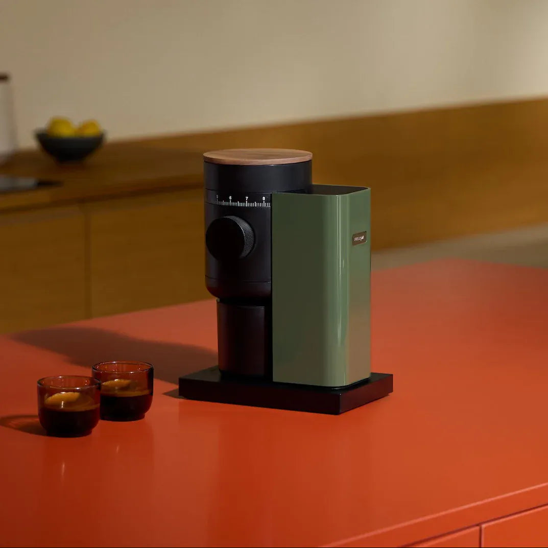 Fellow Opus 2 grinder in Woodland + Walnut with two glasses of cold brew