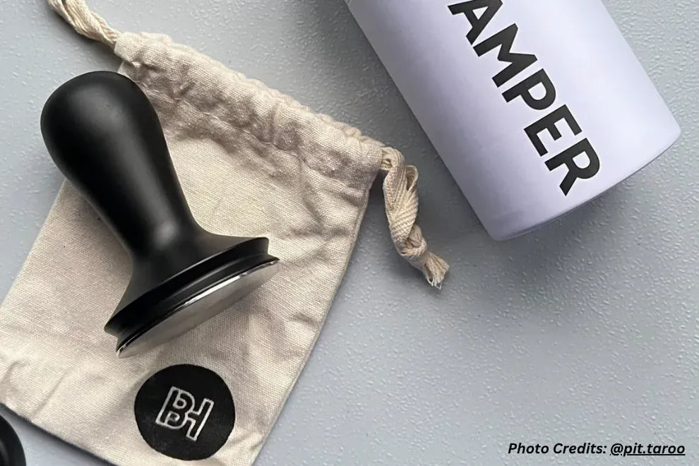 Barista Hustle coffee tamper packed in its branded cotton storage bag