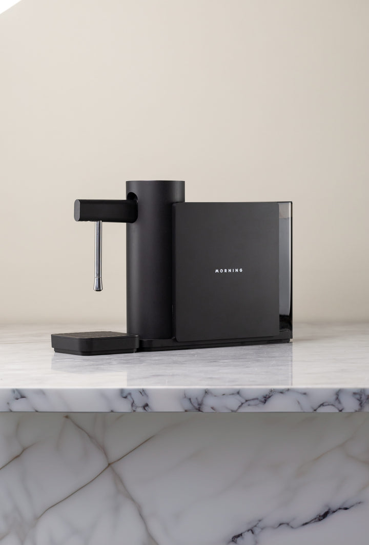 Morning Dream Milk Steamer — Black, on a marble kitchen counter