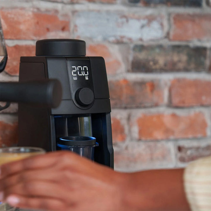 Baratza Encore ESP Pro Electric Coffee Grinder in front of a rustic brick wall