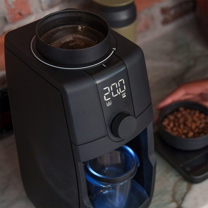 Baratza Encore ESP Pro Electric Coffee Grinder with digital display and glass carafe on a countertop.
