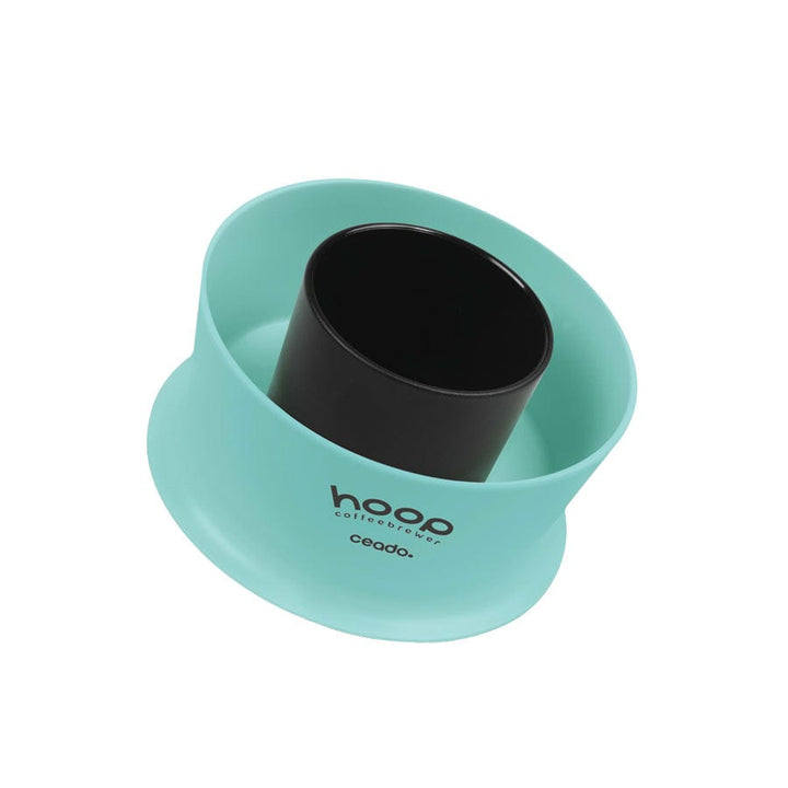 Angled view of the Ceado Hoop Coffee Brewer in aquamarine highlighting its compact shape and modern Italian design