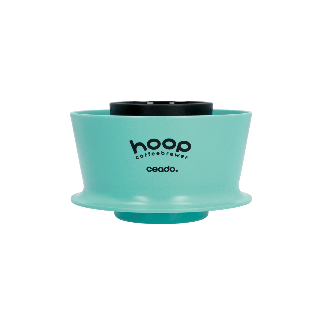 Front-facing product image of the Ceado Hoop Coffee Brewer in aquamarine, showcasing the cylindrical no-bypass design and minimalist construction