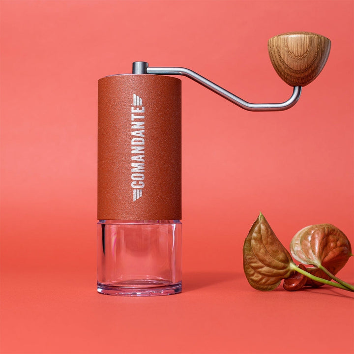 Comandante C40 Nitro Blade Coffee Grinder MK4 in Sunset with wooden handle on a red background