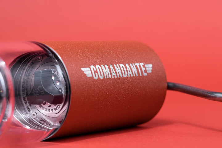 Comandante C40 Nitro Blade Coffee Grinder MK4 in Sunset with 'Comandante' branding on a red background