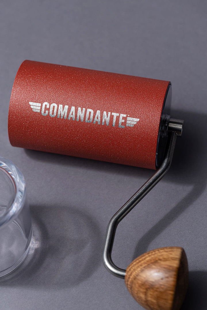 Comandante C40 Nitro Blade Coffee Grinder MK4 in Sunset with 'Comandante' branding on a grey background