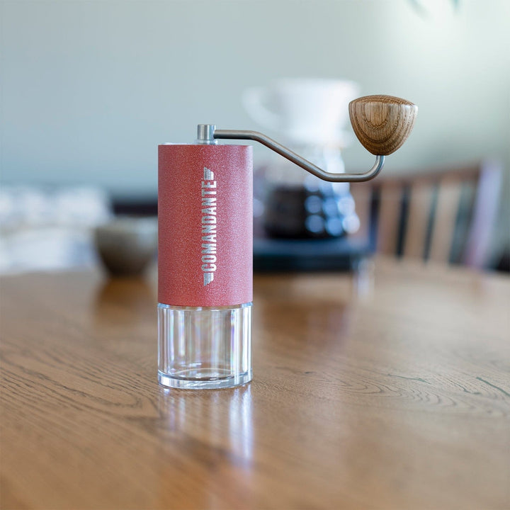 Comandante C40 Nitro Blade Coffee Grinder MK4 in Sunset with wooden handle on a wooden table