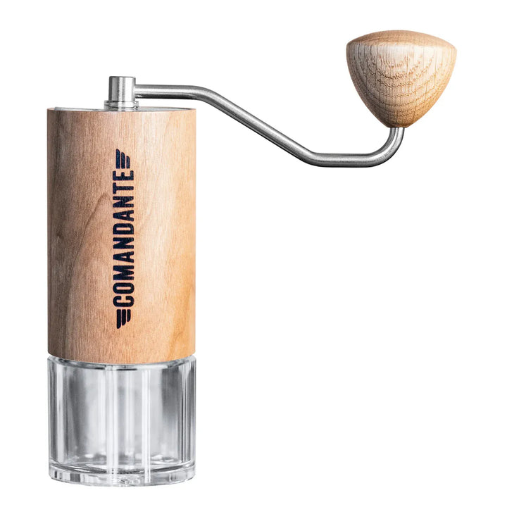 The Comandante C40 Nitro Blade Coffee Grinder MK4 in American Cherry with a clear base and a wooden handle on a white background