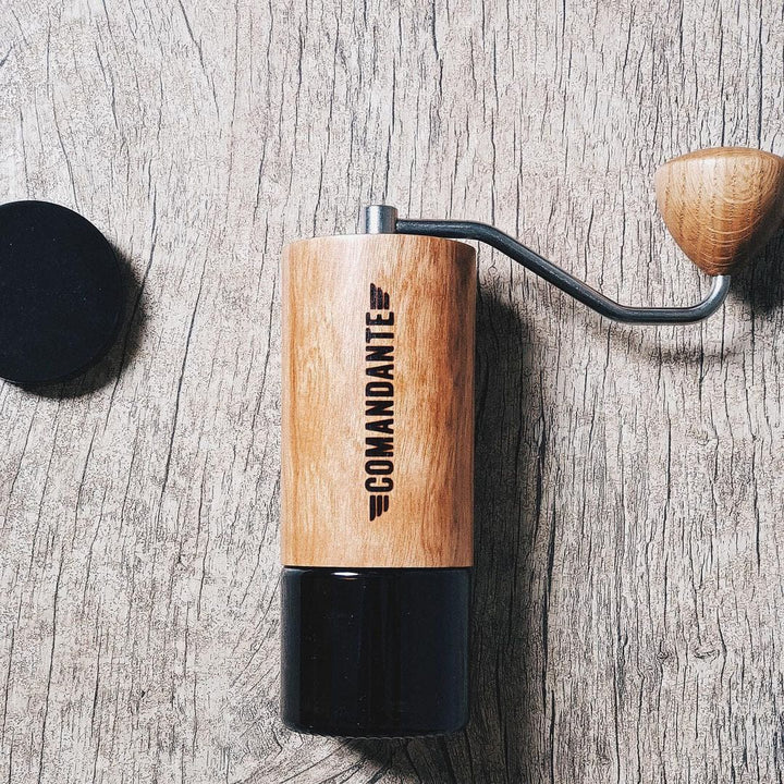Comandante C40 Nitro Blade Coffee Grinder MK4 in American Cherry with 'Comandante' branding on a wooden surface