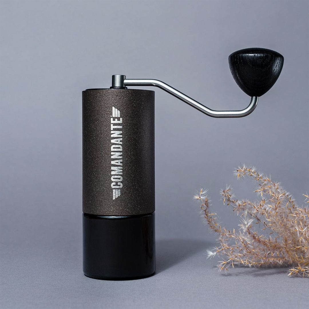Comandante C40 Nitro Blade Coffee Grinder MK4 in Copper Mountain with 'Comandante' branding on a grey background