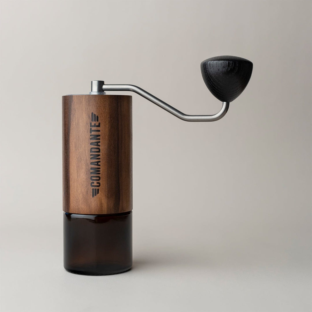 Comandante C40 Nitro Blade Coffee Grinder MK4 in Liquid Amber with a metal handle on a light background