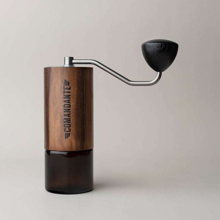Comandante C40 Nitro Blade Coffee Grinder MK4 in Liquid Amber with a metal handle on a light background