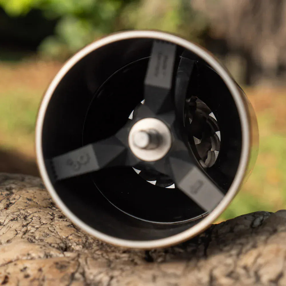 Top View Close-up of a Comandante C40 Nitro Blade Coffee Grinder MK4 in Liquid Amber on a natural background