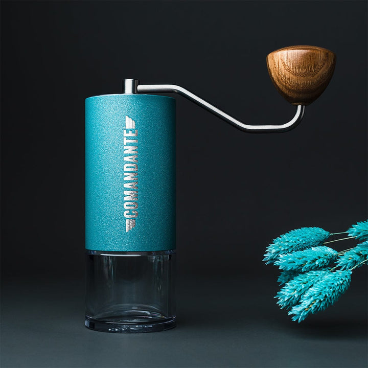 Comandante C40 Nitro Blade Coffee Grinder MK4 in Alpine Lagoon with wooden handle on a dark background