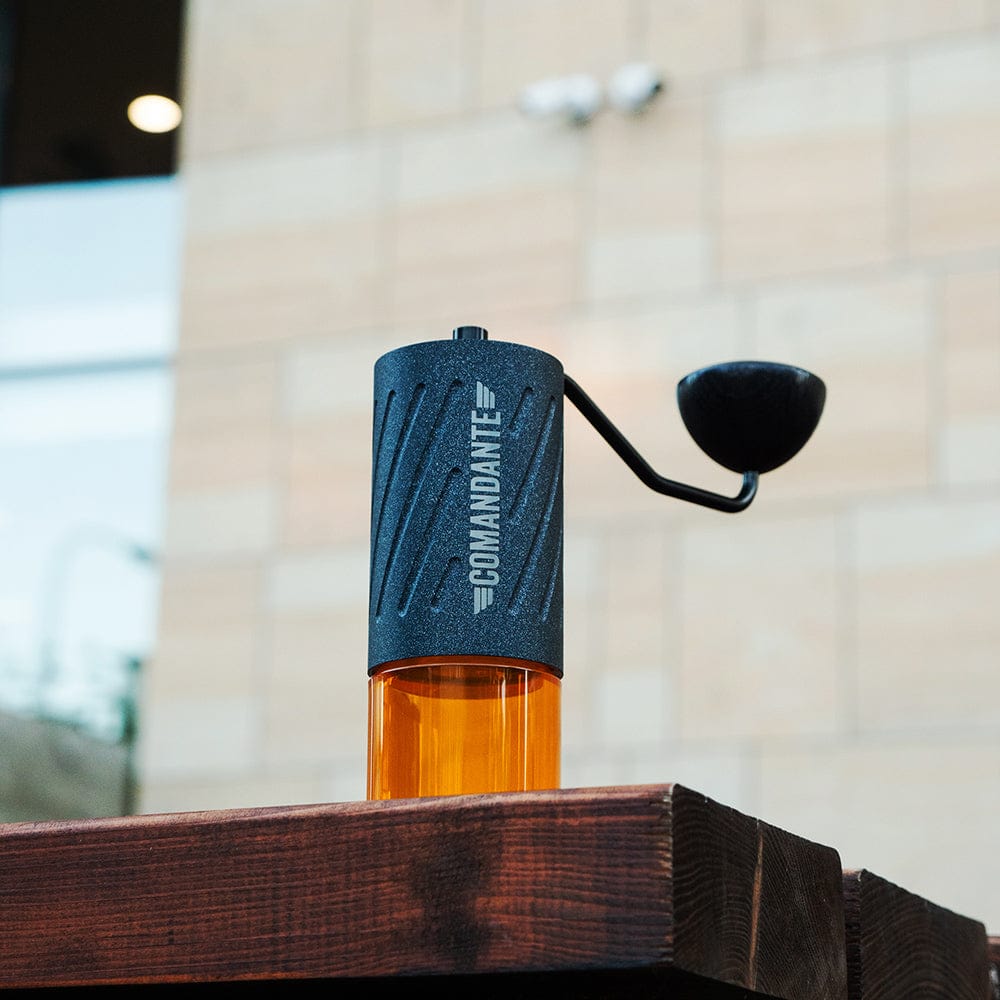 Comandante C60 Baracuda Coffee Grinder in Nautilus Blue with 'Comandante' branding on a wooden surface.