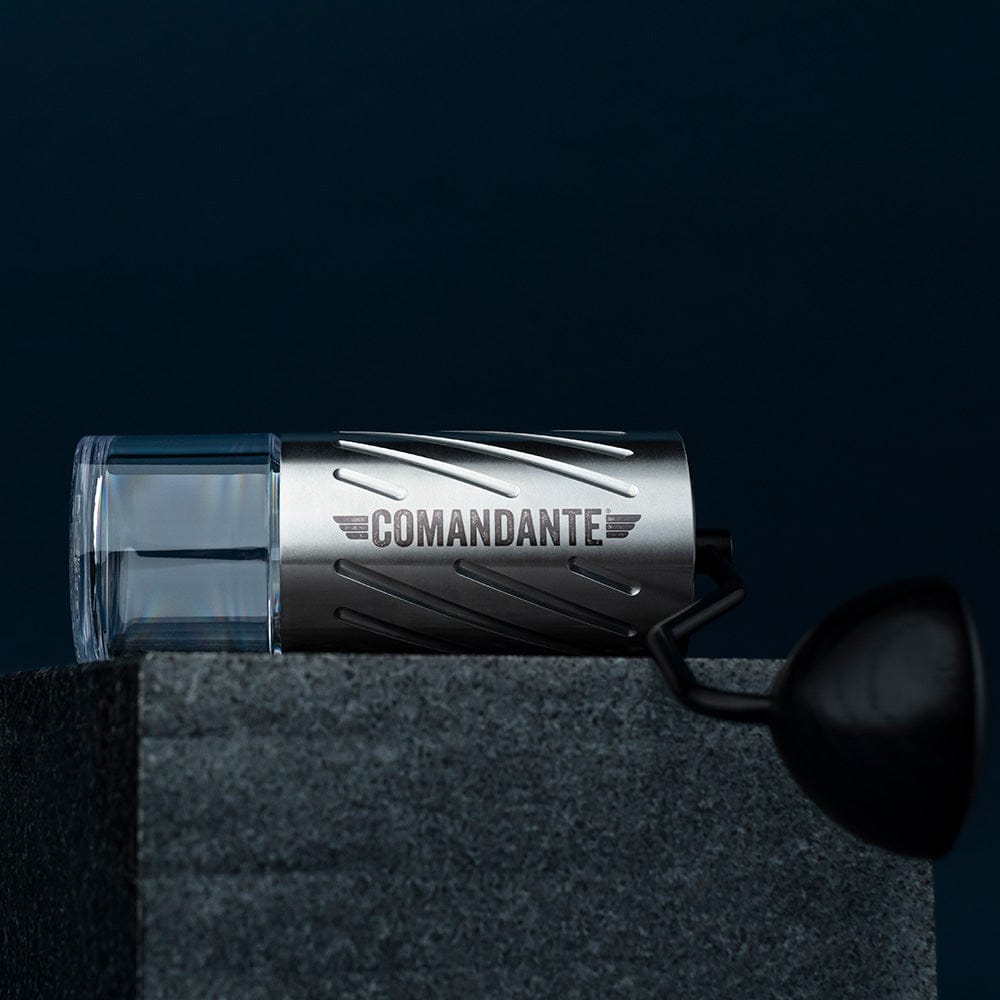 Comandante C60 Baracuda Coffee Grinder in Velvet Steel with 'Comandante' branding on a dark background