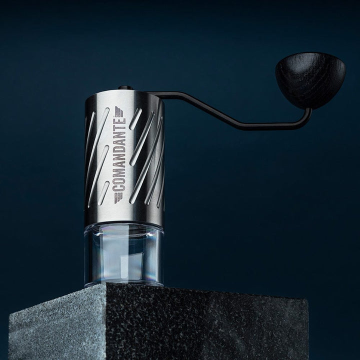 Comandante C60 Baracuda Coffee Grinder in Velvet Steel with 'Comandante' branding on a dark background