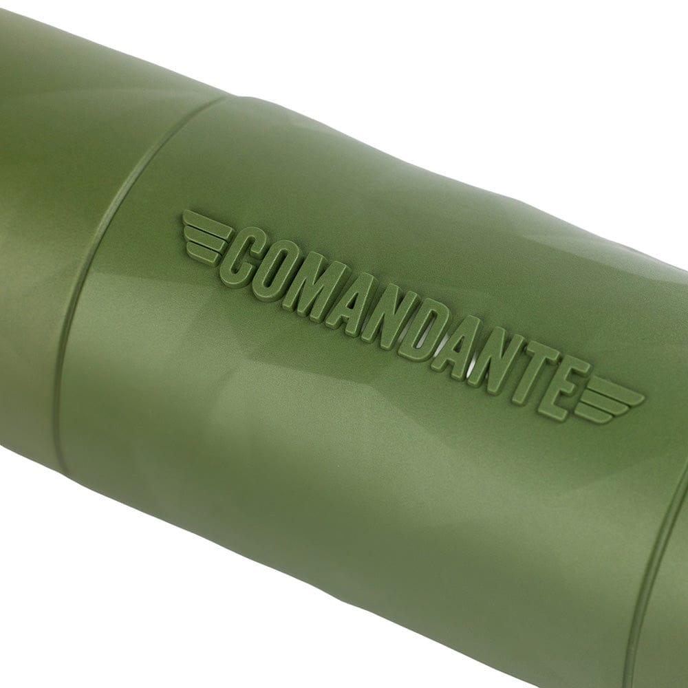 Close-up of a Comandante X25 Trailmaster Coffee Grinder in Forest Green with 'COMANDANTE' branding on a white background
