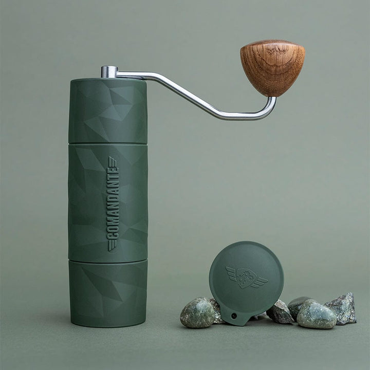 Comandante X25 Trailmaster Coffee Grinder in Forest Green with wooden handle on a grey background