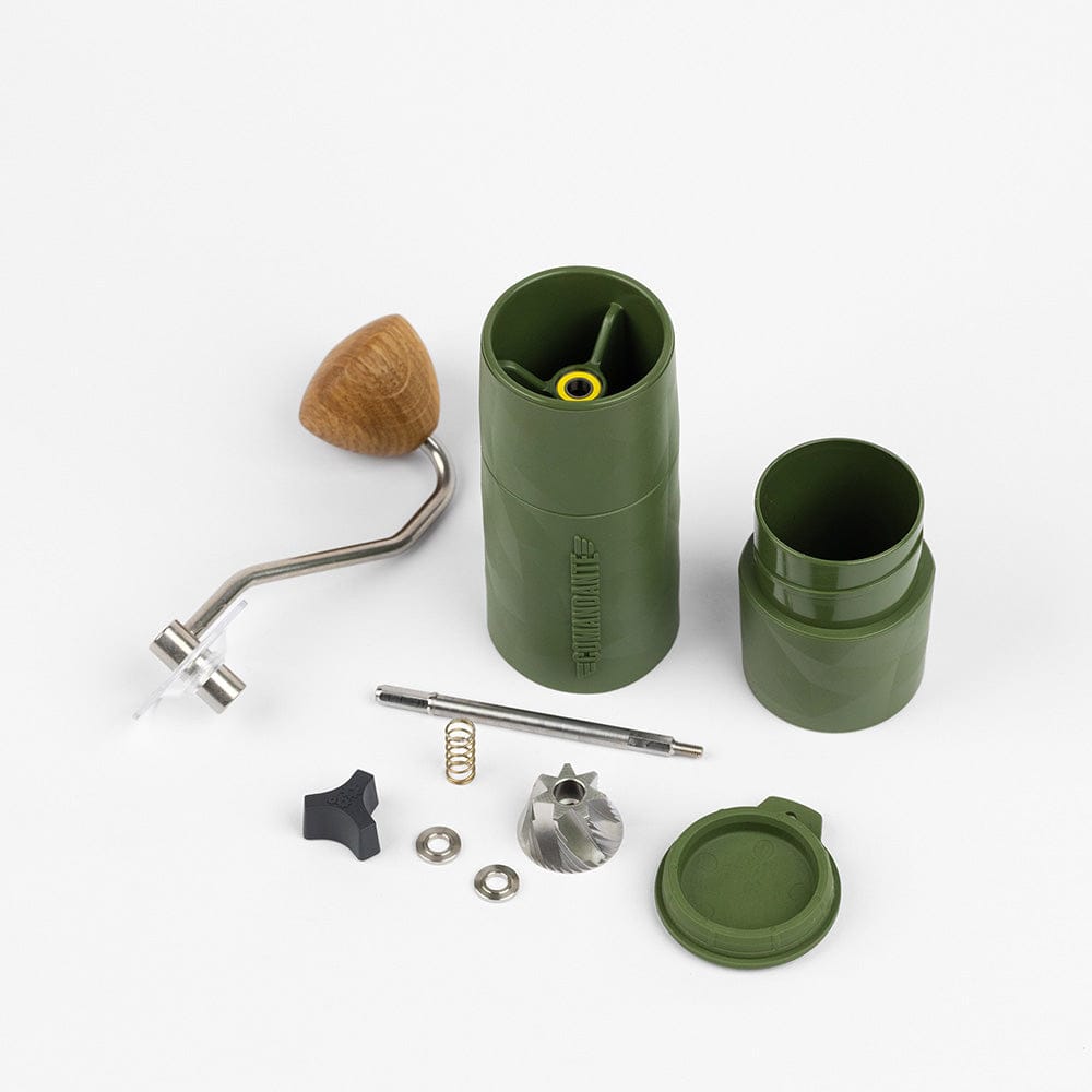 Comandante X25 Trailmaster Coffee Grinder in Forest Green with various parts on a white background