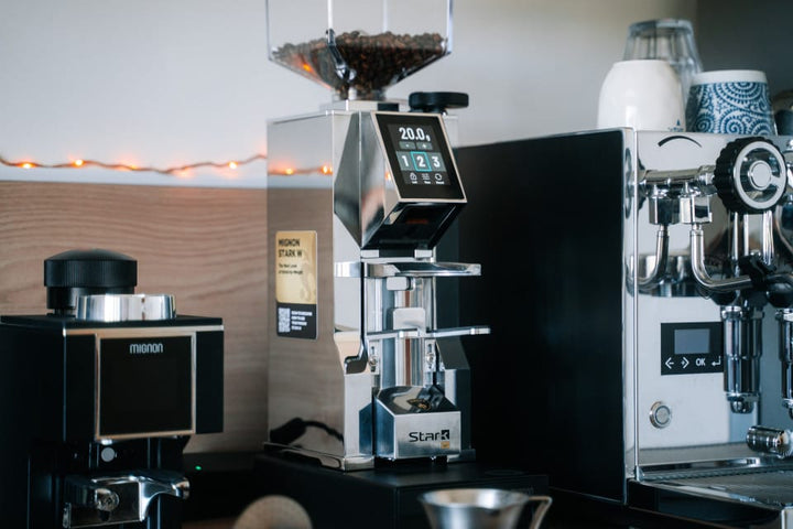 Eureka Mignon Stark W 65 in Chrome on a home espresso bar beside an espresso machine