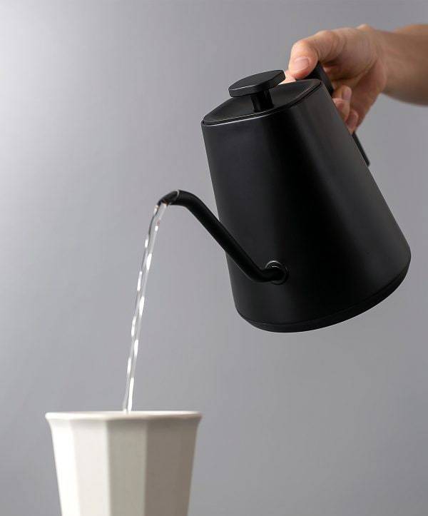 Felicita Square Temperature Control Electric Kettle being used to pour water into a white cup on a grey background