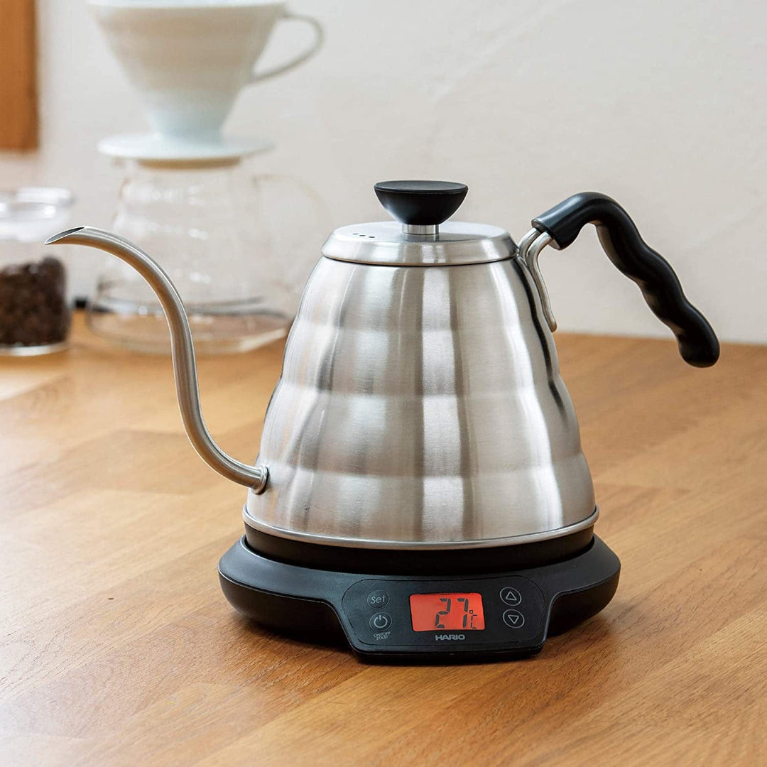 Stainless steel Hario Buono Gooseneck V60 Power Kettle with Temperature Adjustment with a digital display on a wooden surface