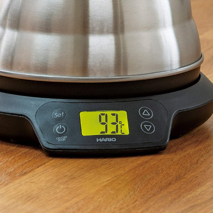 Stainless steel Hario Buono Gooseneck V60 Power Kettle with Temperature Adjustment with a digital display on a wooden surface