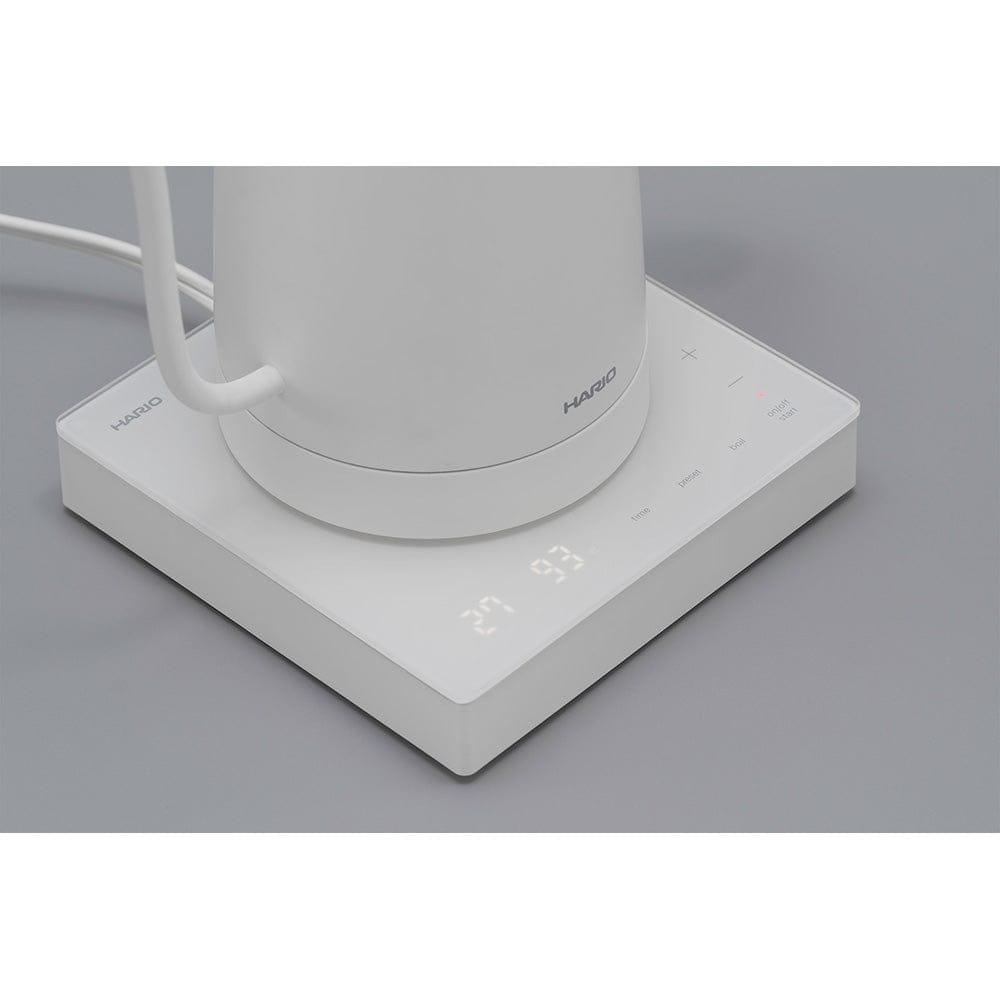 White Hario Lyra Gooseneck Kettle with digital display on a grey surface