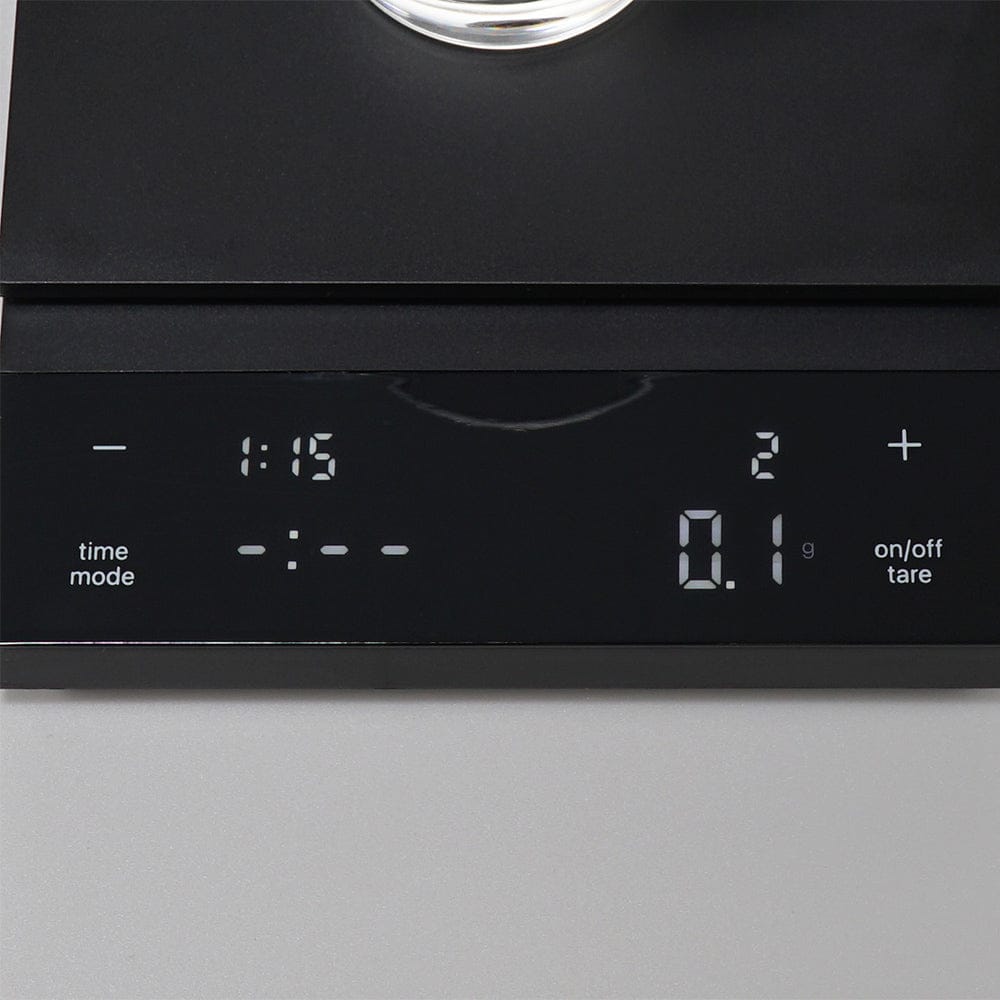 Hario Polaris Coffee Scale in Black with time, mode, weight, and tare display on a grey background