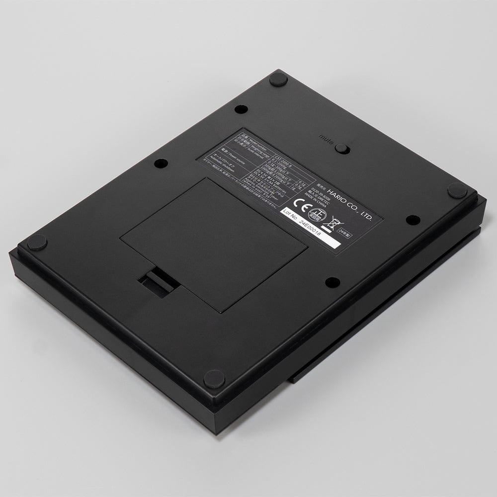 Underside view of Hario Polaris Coffee Scale in Black on a grey background