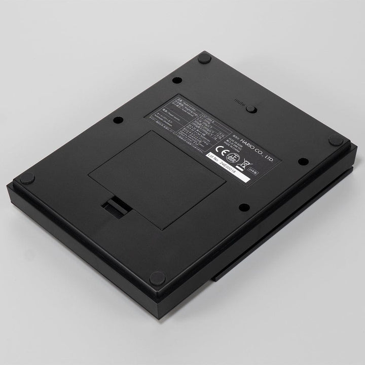 Underside view of Hario Polaris Coffee Scale in Black on a grey background
