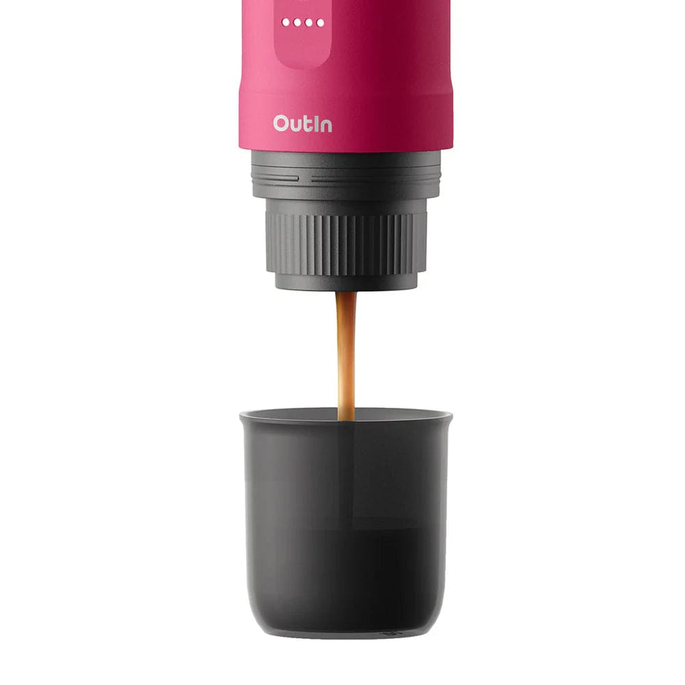 OutIn Nano Portable Espresso Coffee Machine in Fuchsia Pink with coffee being dispensed into a black cup on a white background