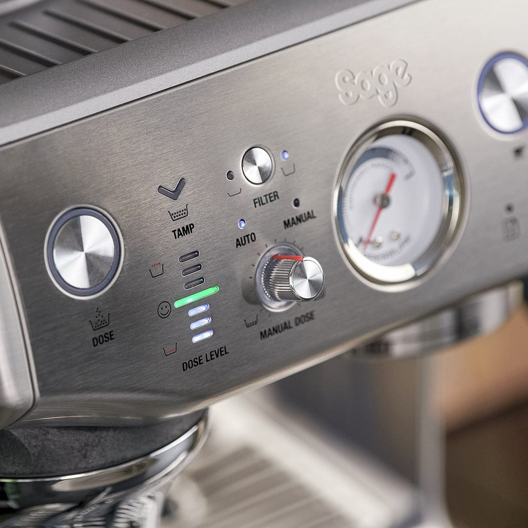Close-up of a Stainless steel Sage Barista Express Impress Espresso Machine with control panel and display.