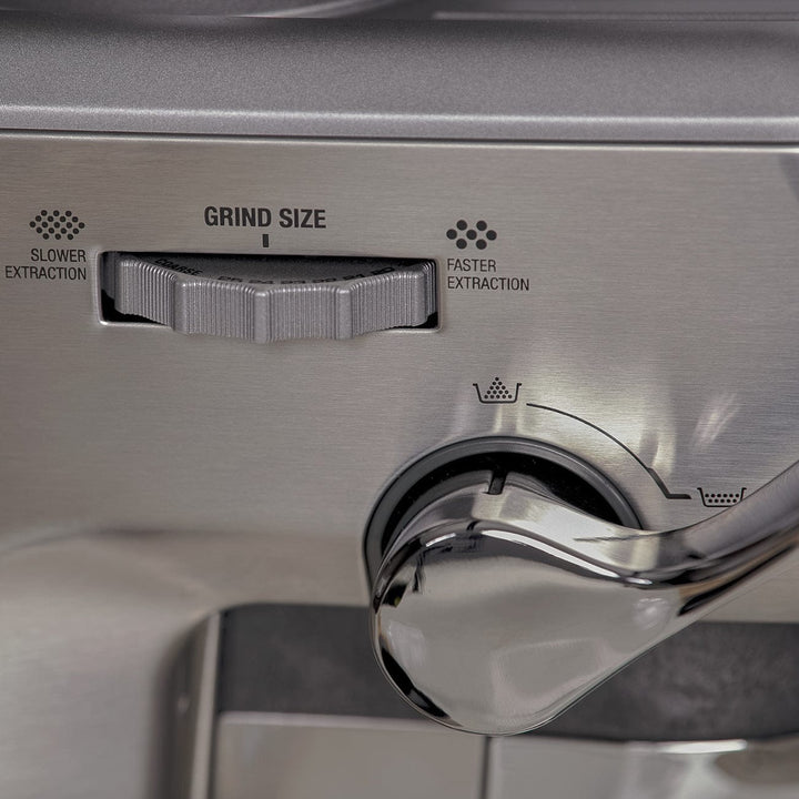 Close-up of a Stainless steel Sage Barista Express Impress Espresso Machine grind size dial and lever.