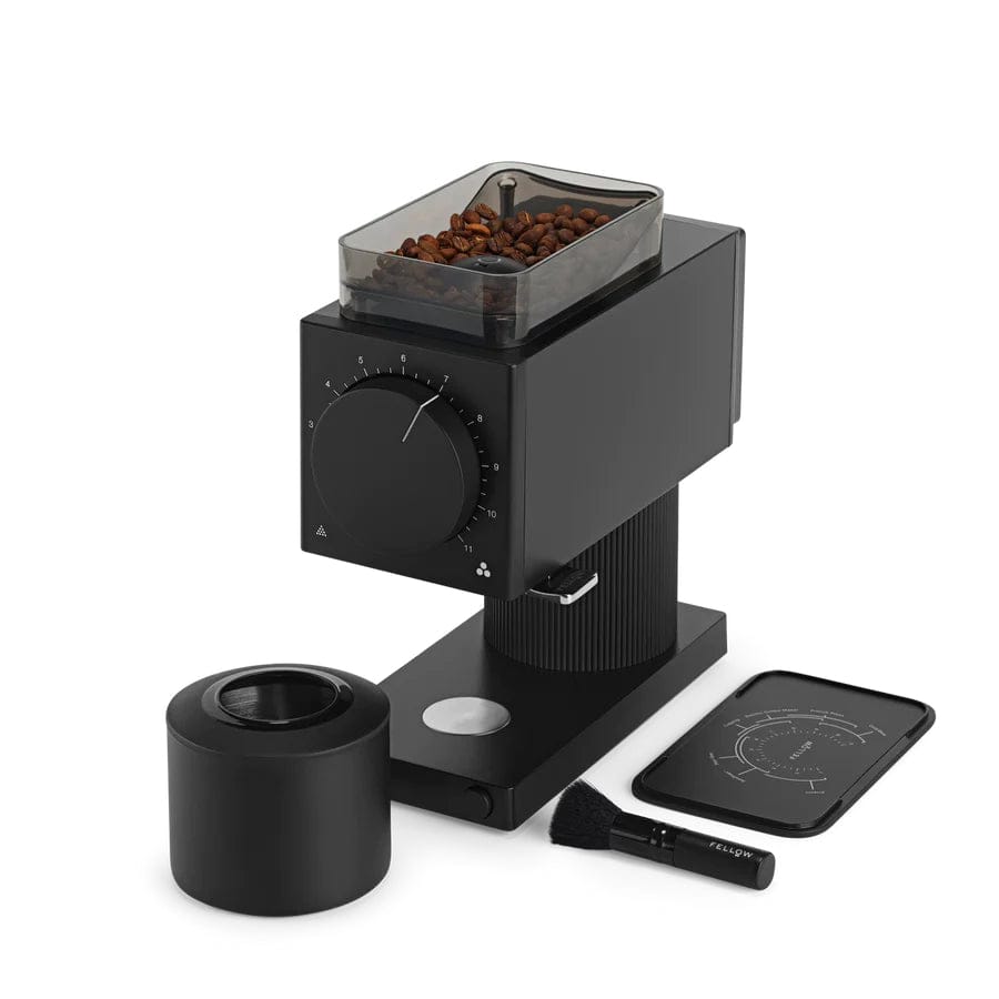 Black Fellow Ode Gen 2 Electric Coffee Grinder with beans, cleaning brush, and tray on a white background
