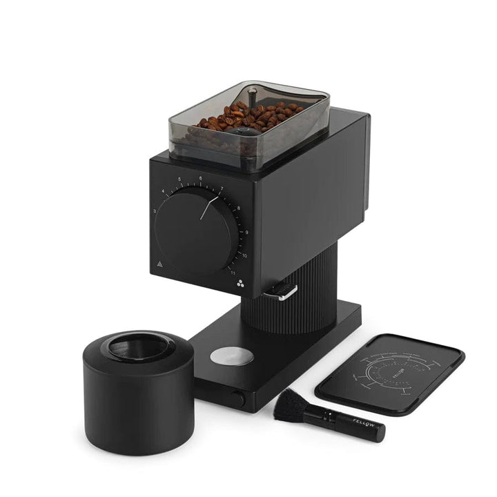 Black Fellow Ode Gen 2 Electric Coffee Grinder with beans, cleaning brush, and tray on a white background
