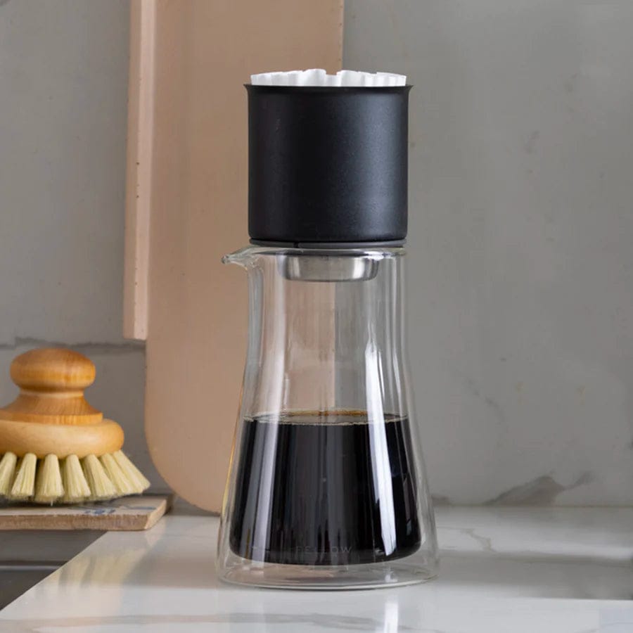 Fellow Stagg Double Wall Glass Carafe with a black Fellow Stagg dripper on top on a kitchen counter
