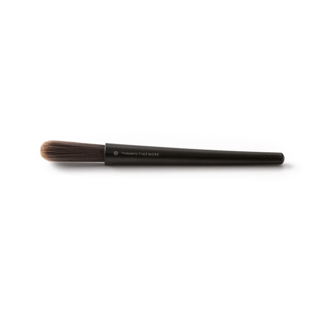 Black cleaning brush with brown bristles for the Timemore Chestnut C2 Manual Coffee Grinder in White on a white background