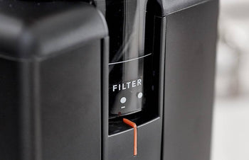 Wilfa Svart Aroma Precision Coffee Grinder in Black with a grind adjustment and a blurred background